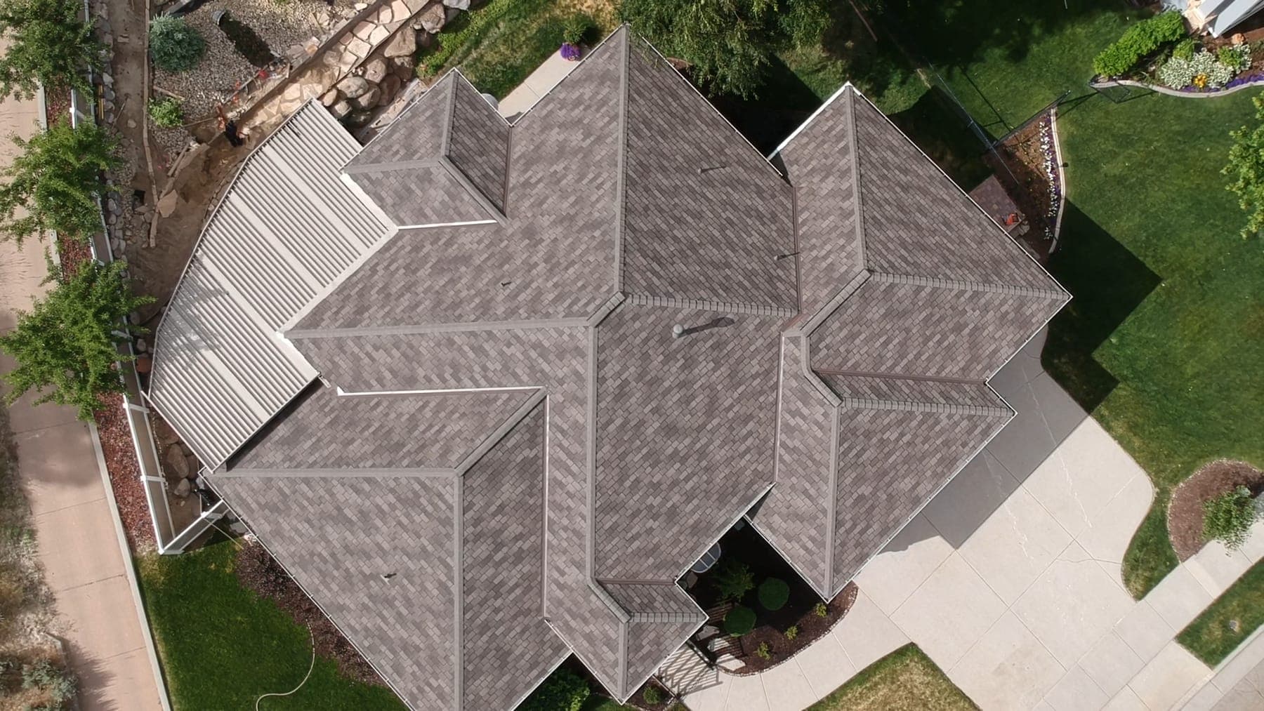 Aerial view of a Utah neighborhood roof after a storm, photographed for an insurance claim